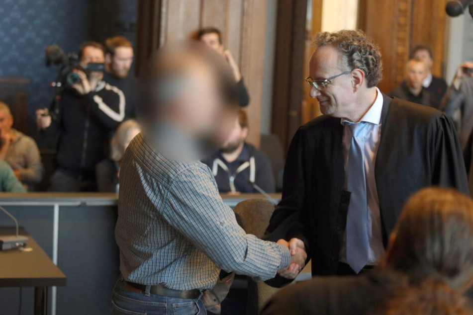 Bei dem Prozess wegen illegalen Waffenbesitzes begrüßt der Angeklagte seinen Verteidiger.