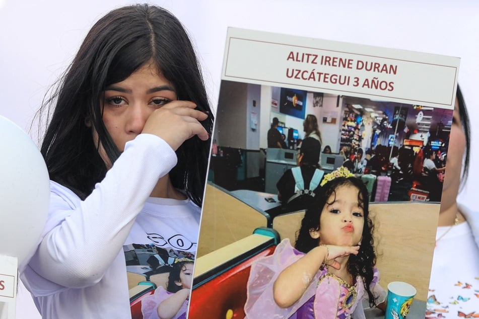 A woman cries during a demonstration for children who remain in the US after being separated from their parents, in Caracas, Venezuela, on July 10, 2025.