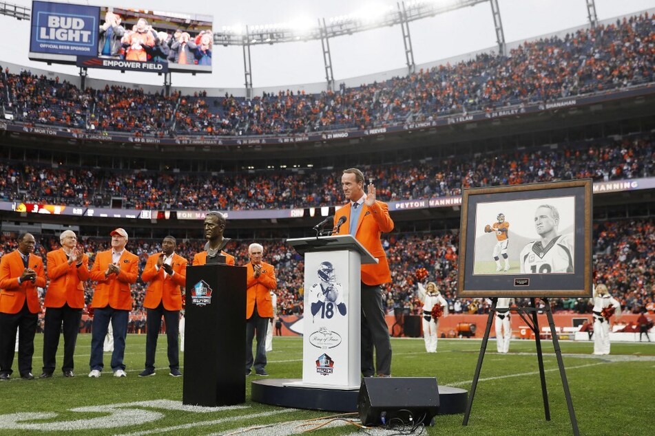 Peyton Manning speaks to the crowd during a Ring of Honor induction ceremony at halftime of the game between the Washington Football Team and Denver Broncos at Empower Field At Mile High.