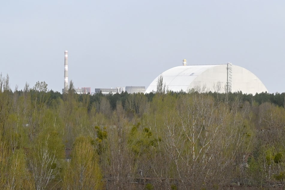 The New Safe Confinement covering the destroyed fourth reactor at the Chernobyl Nuclear Power Plant is seen from the ghost city of Pripyat on April 23, 2026.
