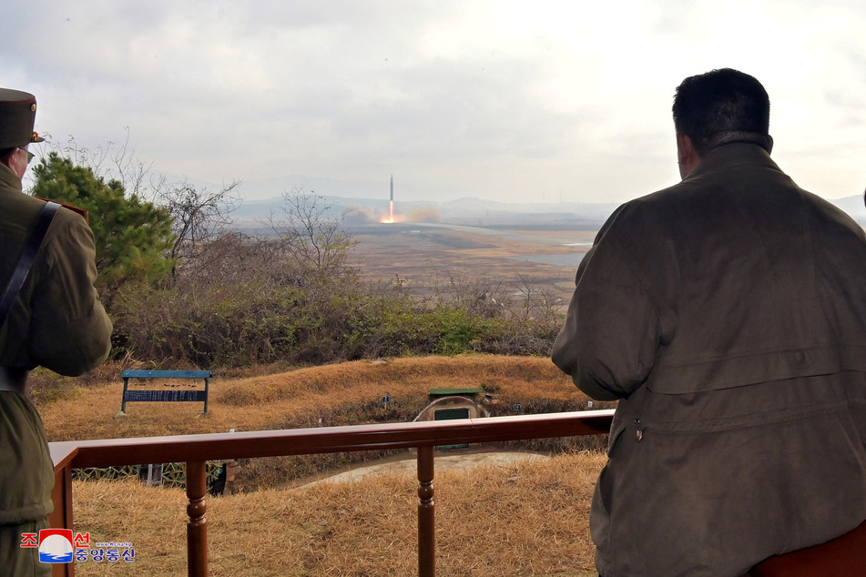 North Korean leader Kim Jong Un watches the launch of an intercontinental ballistic missile.