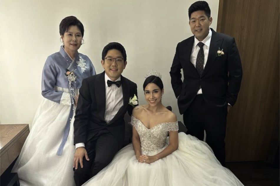 Tae Heung "Will" Kim (r.) poses for a photo with his mother Sharon Lee (l.), brother Tae Kwon Kim (second from l.), and new sister-in-law Emily.