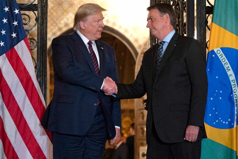 US President Donald Trump (l.) shakes hands with Brazilian President Jair Bolsonaro (r.) during a diner at Mar-a-Lago in Palm Beach, Florida, on March 7, 2020.