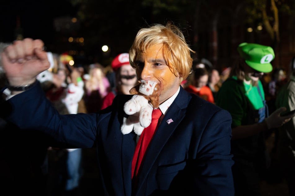 Attracting a crowd of tens of thousands, the parade revelers, many of whom wore costumes pillorying prominent politicians, sauntered through central Manhattan on an unseasonably mild evening.