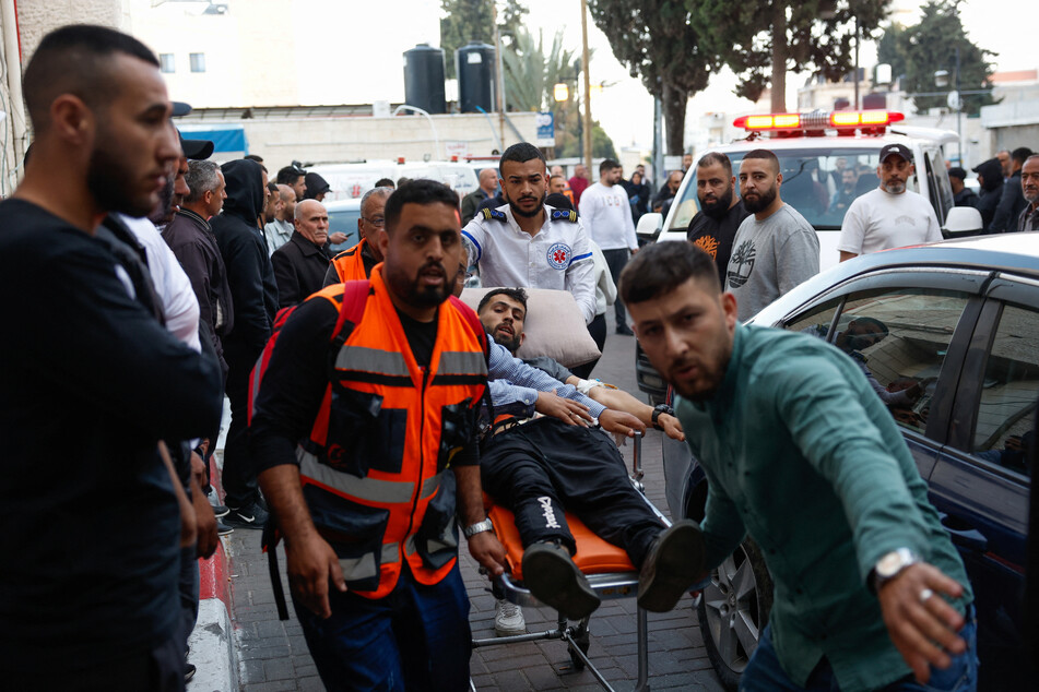 One Palestinian was killed and dozens more were injured after Israeli settlers backed by the army attacked a village, carrying arms and stones.