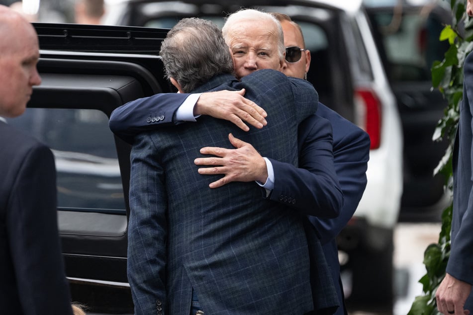 US President Joe Biden (r.) hugs his son Hunter Biden as they leave The Ivy restaurant in Los Angeles, California, February 4, 2024.