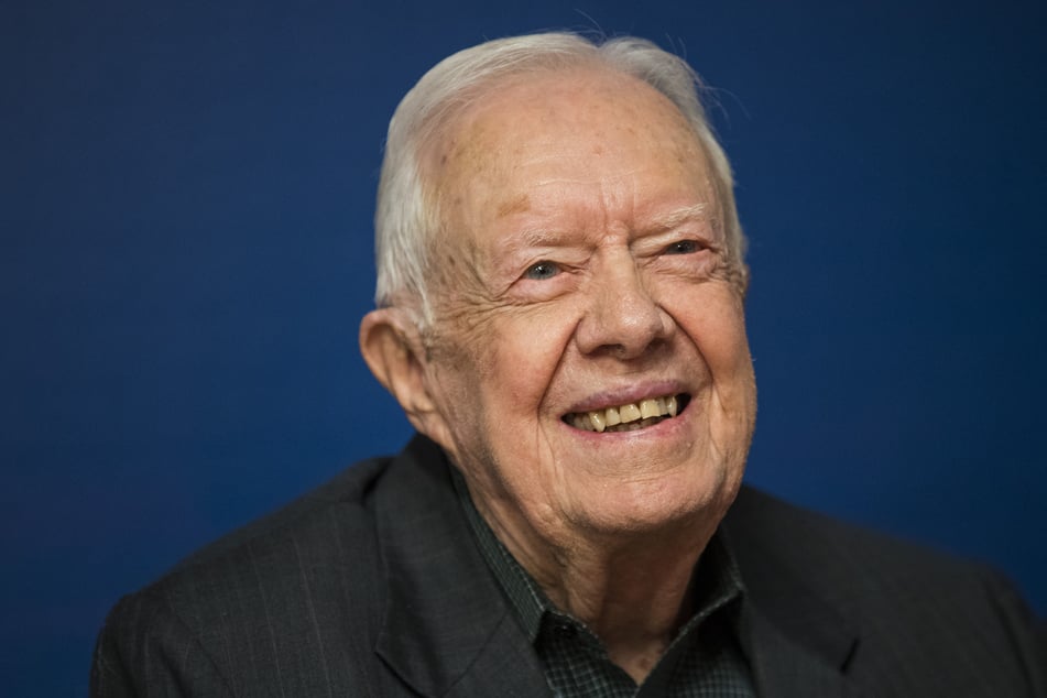 Former US President Jimmy Carter smiles at a book signing event for his book, Faith: A Journey For All, in Midtown Manhattan, March 26, 2018, in New York City.