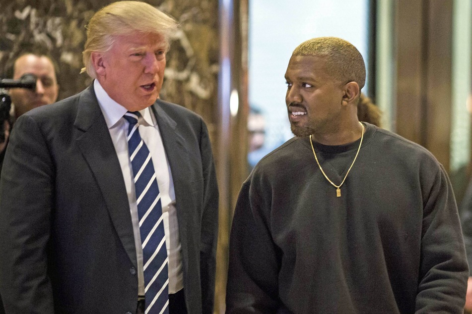 Kanye West (r.) with then President Donald Trump meeting in the lobby of Trump Tower in Manhattan on December 13, 2016.