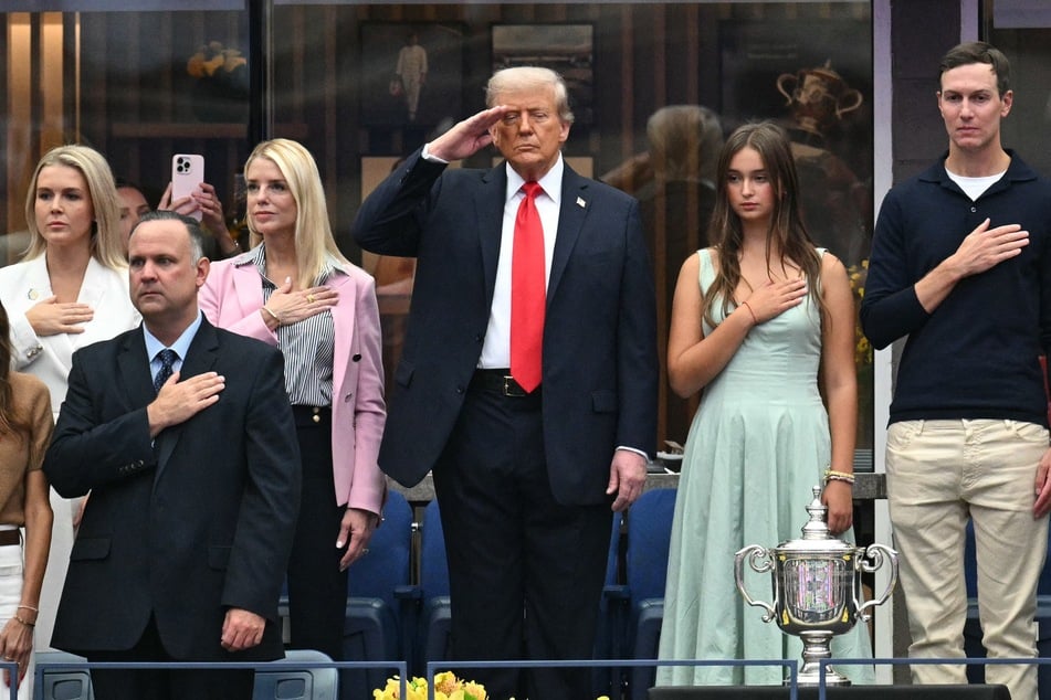 President Donald Trump, joined by, L-R, White House Press Secretary Karoline Leavitt, US Attorney General Pam Bondi, his granddaughter Arabella Kushner, and Jared Kushner salutes as they listen the national anthem during the men's singles final tennis match between Spain’s Carlos Alcaraz and Italy’s Jannik Sinner at the USTA Billie Jean King National Tennis Center in New York City, on Sunday.
