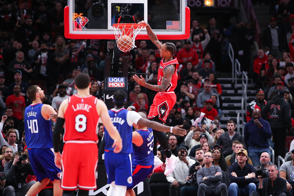 Bulls forward DeMar DeRozan dunks the ball during overtime on Thursday night.