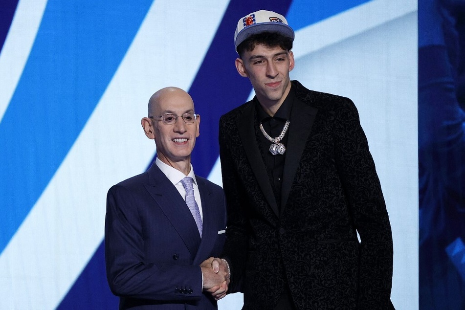 NBA commissioner Adam Silver (L) and Chet Holmgren pose for photos after Holmgren was drafted with the 2nd overall pick by the Oklahoma City Thunder during the 2022 NBA Draft.