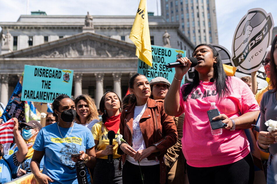 Angelika Maldonado of the Amazon Labor Union stands next to AOC as she speaks out in support of workplace organizing efforts.