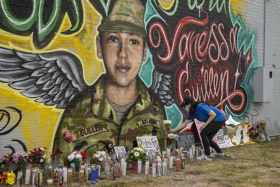 Mourners leave flowers and candles by a mural of Fort Hood Spc. Vanessa Guillén outside a convenience store in Austin.