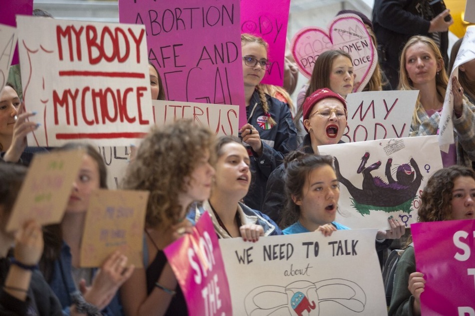Demonstrators protest efforts to restrict abortion access at the State Capitol Building in Salt Lake City, Utah.