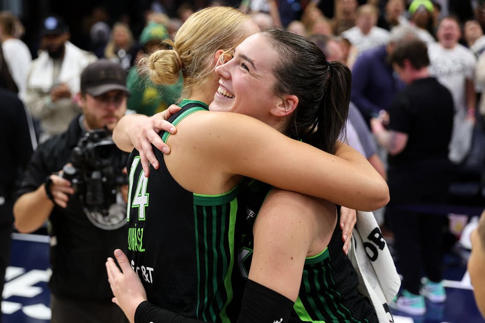 Minnesota Lynx forward Bridget Carleton (r.) and forward Dorka Juhasz celebrate their team's win after game four of the 2024 WNBA Finals against the New York Liberty at Target Center.