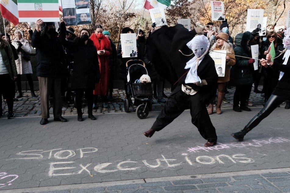 People gather outside of an Iranian diplomat's residence to denounce the Iranian government and the recent execution of a protester on December 10, 2022, in New York City.