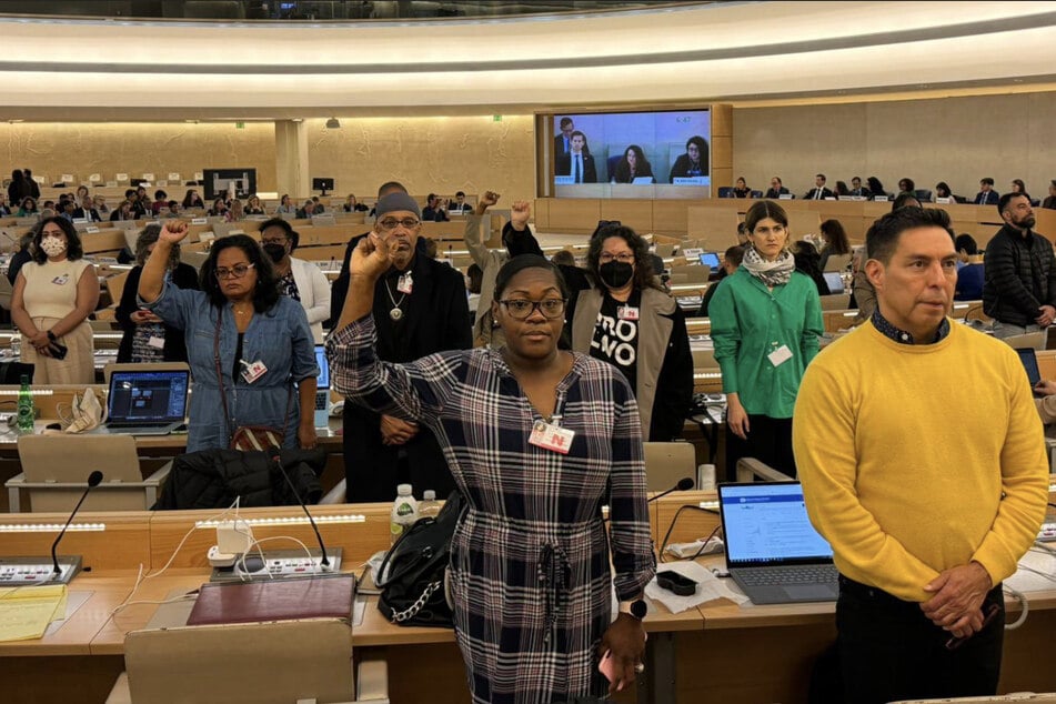 Civil society representatives turn their backs on US government officials in silent protest at the end of the United Nations Human Rights Committee's two-day review.
