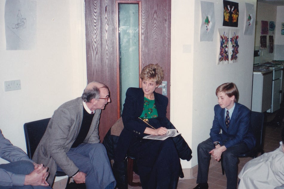 This handout photograph released by Kensington Palace on October 25, 2024, shows Britain's Princess Diana (c.) with her 11-year-old son William (r.), now Britain's Prince William, Prince of Wales during one of his first visits to homelessness charity, The Passage in London, taken on December 14, 1993.