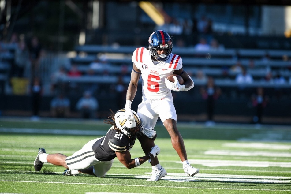 Zach Evans of the Ole Miss Rebels runs the ball through a Vanderbilt Commodores during their conference play Week 6 of college football.