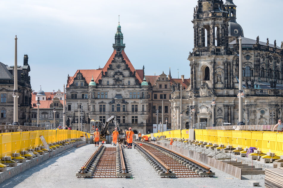 Bauarbeiter verlegen auf der Augustusbrücke erste Gleise. Wahrscheinlich Ende des Jahres soll alles fertig sein, danach können wieder Bahnen über die Elbquerung fahren.