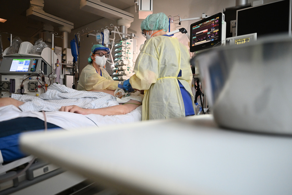 Ayse Yeter, Krankenschwester und Stationsleitung der Intensivstation für Covid-19 Patienten des Klinikum Stuttgart, pflegt einen Patienten, der im künstlichen Koma liegt und beatmet wird, in einem Intensivbett.
