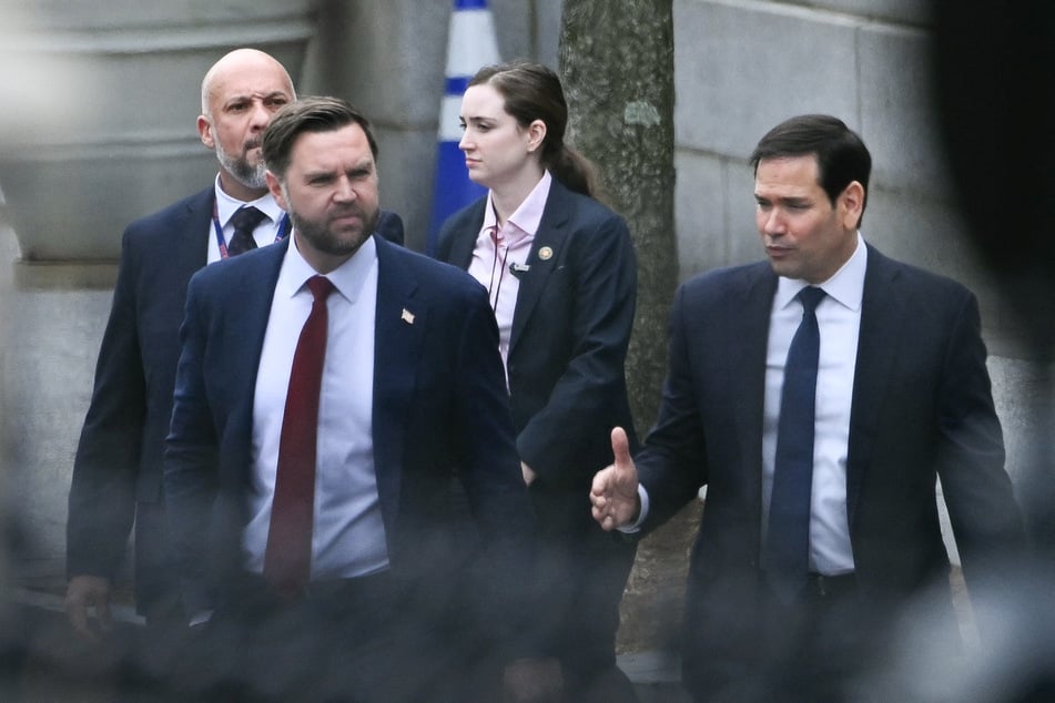 Vice President JD Vance and Secretary of State Marco Rubio depart the Eisenhower Executive Office Building on the White House campus on January 14, 2026.