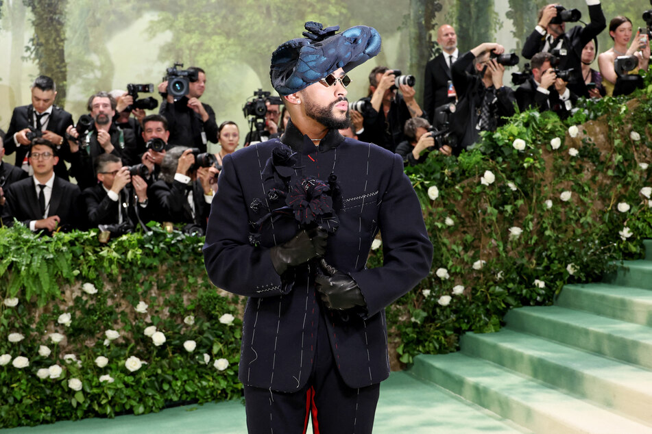 Bad Bunny sported a Tudor-inspired outfit featuring a sweeping hat and black bouquet.