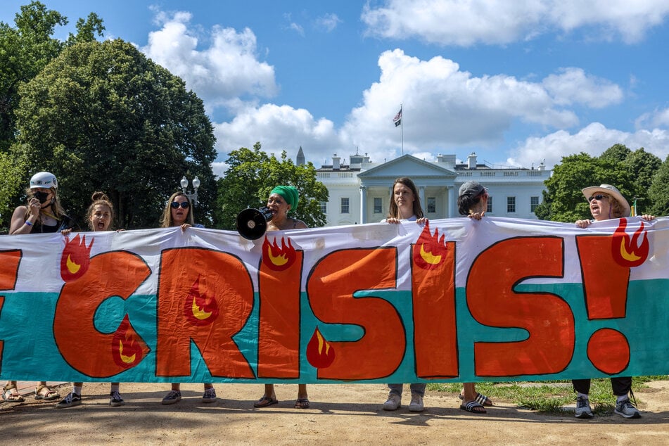 Activists chant as they occupy Lafayette Park near the White House calling for bold climate action.