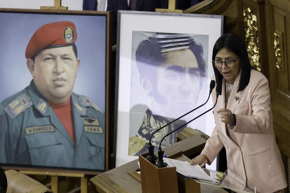 Venezuela's Vice President Delcy Rodriguez speaks past portraits of late Venezuelan President Hugo Chavez and the liberator Simon Bolivar during the presentation of the 2026 fiscal year budget at the National Congress in Caracas on December 4, 2025.