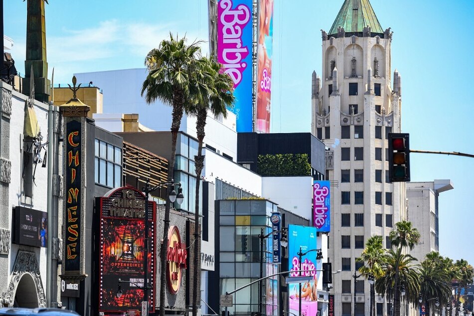 Advertisements for the Oppenheimer movie are seen on the Chinese Theater marquee, while the Barbie movie poster is seen above the Hollywood Walk of Fame, on release day in Los Angeles, California, on July 21, 2023.