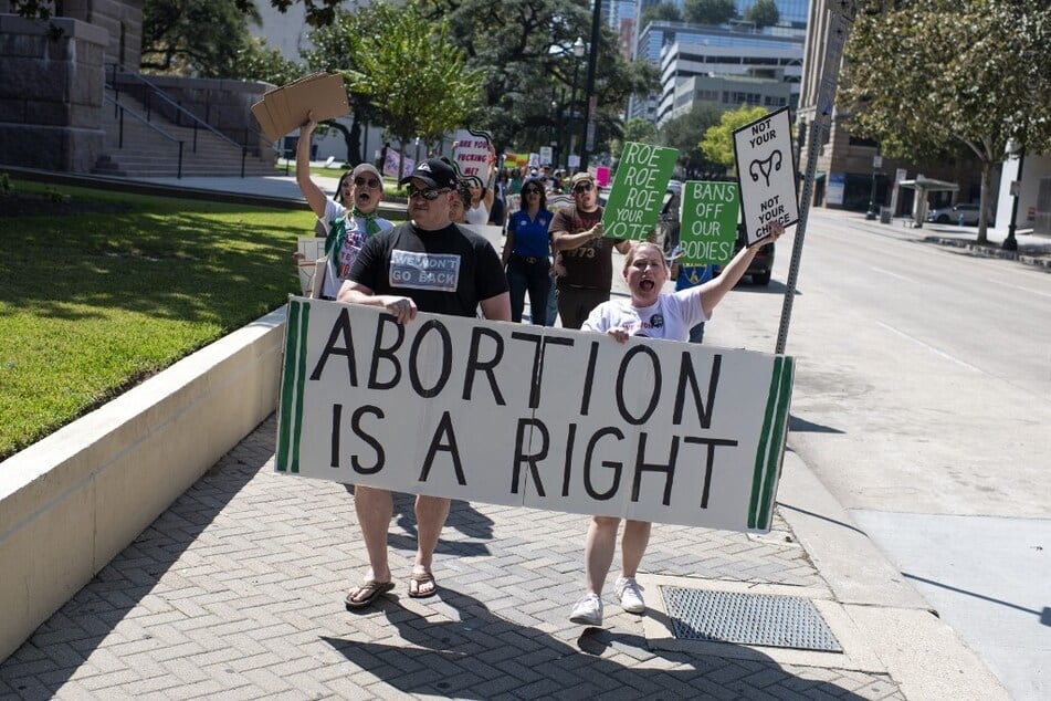 Abortion rights demonstrators gather outside of the Harris County Courthouse during the Women's Wave march in Houston, Texas.