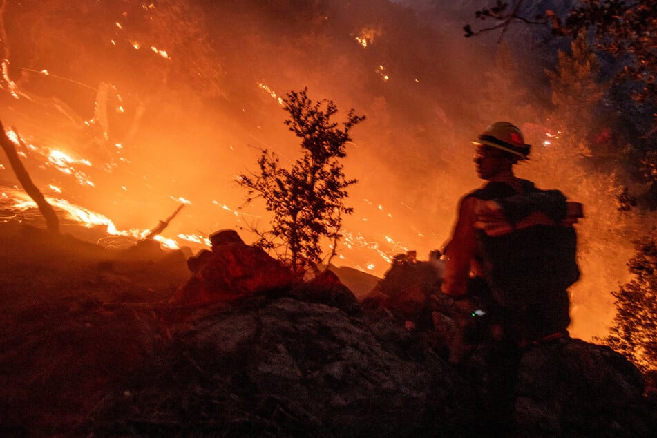 A firefighter battles a blaze in the Angeles National Forest near Mt. Wilson during the Eaton Fire in Altadena, California, on January 9, 2025.