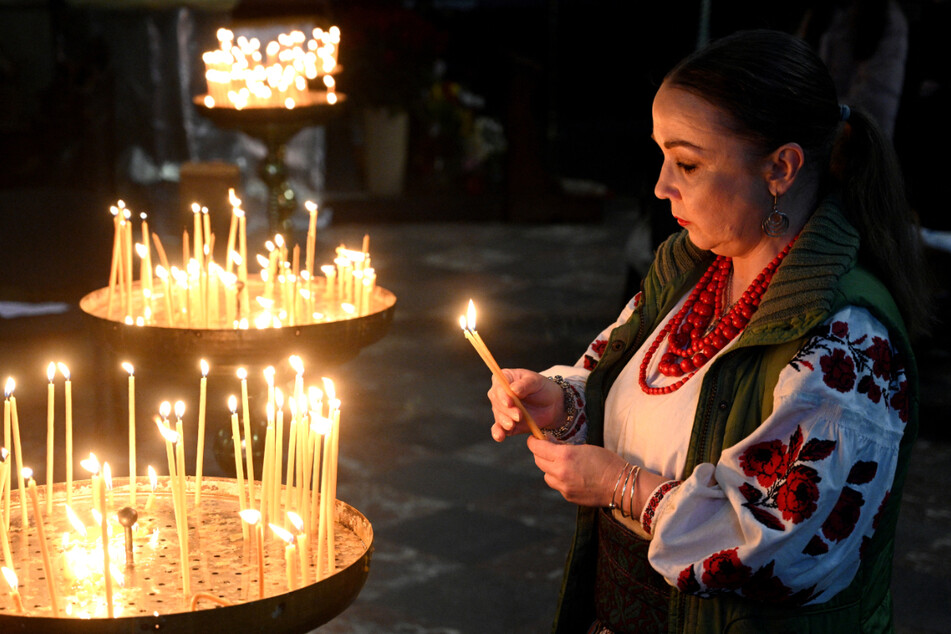 A woman lights a candle on the eve of Orthodox Easter in the western Ukrainian city of Lviv, on Saturday, amid the ongoing Russian invasion of Ukraine.
