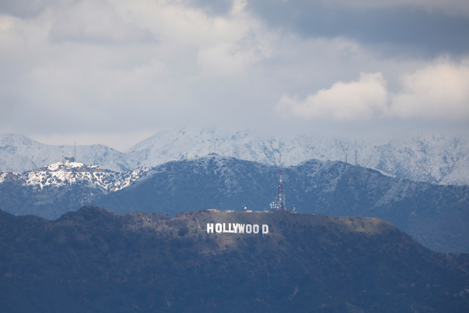 Snow can be seen on the mountains behind the Hollywood sign following a cold winter storm in Los Angeles, California.