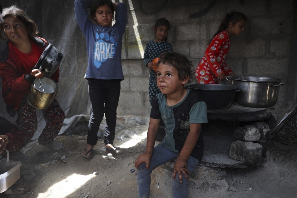 Displaced Palestinian children line up to receive food in Rafah, in the southern Gaza Strip.