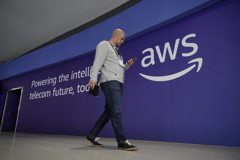A visitor walks past the logo of Amazon Web Services during the Mobile World Congress in Barcelona, Spain, on March 2, 2026.