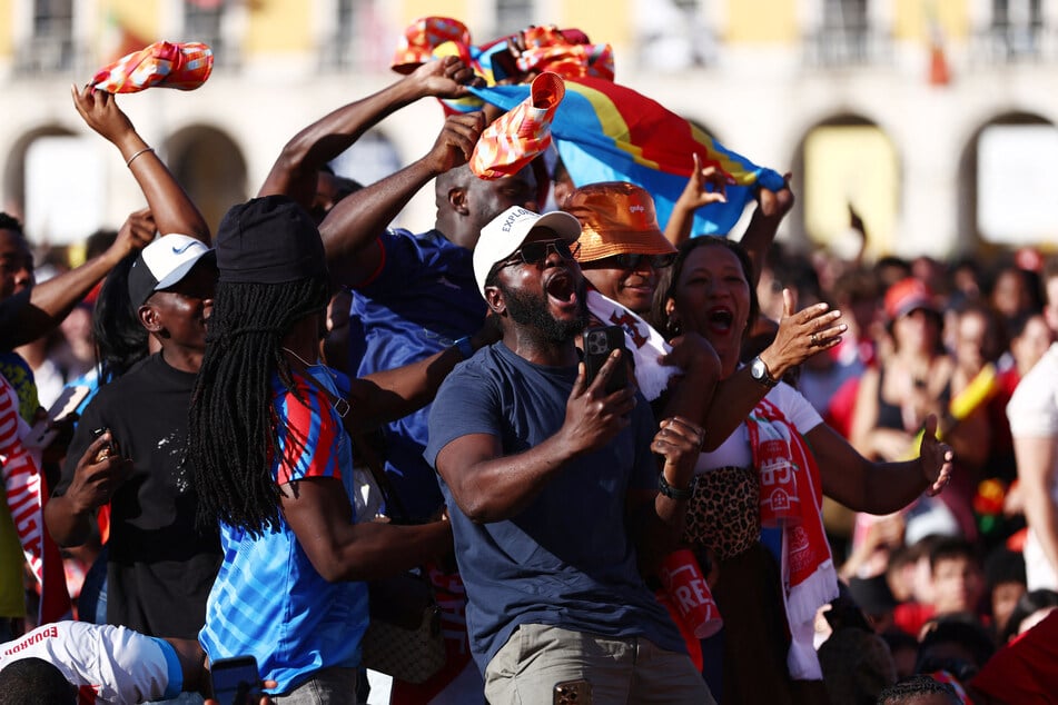 DR Congo fans in Lisbon, Portugal, celebrate their first goal scored by Yoane Wissa.