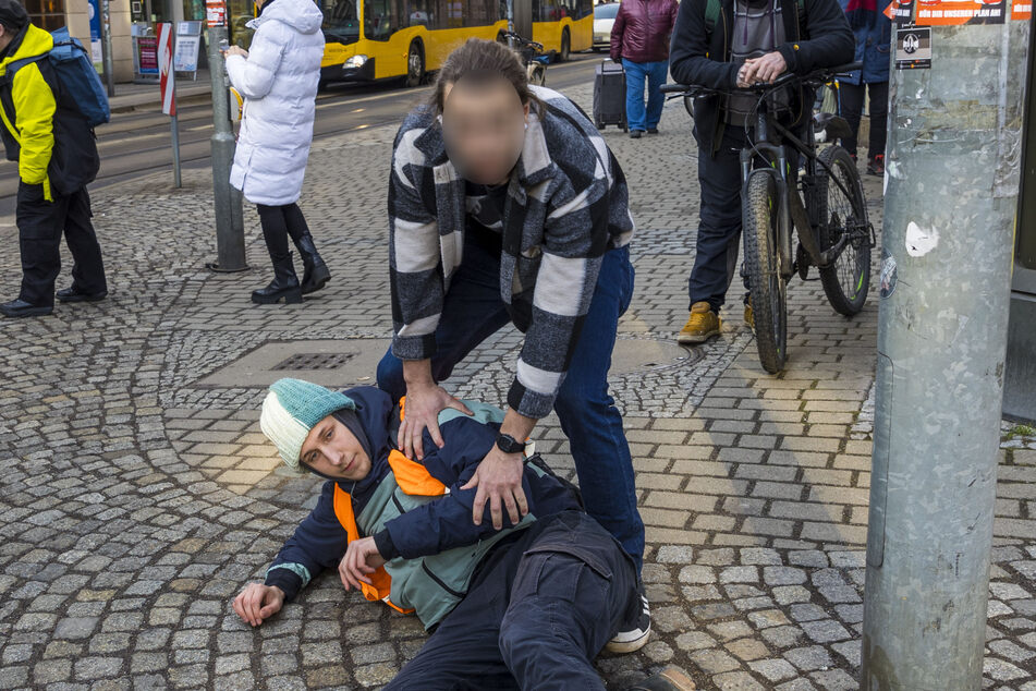 Rückblick auf Donnerstag: Der Dresdner Polizist (hier im Karohemd) sieht sich mit dem Anfangsverdacht einer Körperverletzung im Amt konfrontiert. Er war offenbar zu hart gegen Lars Ritter (19, hier am Boden liegend) vorgegangen.