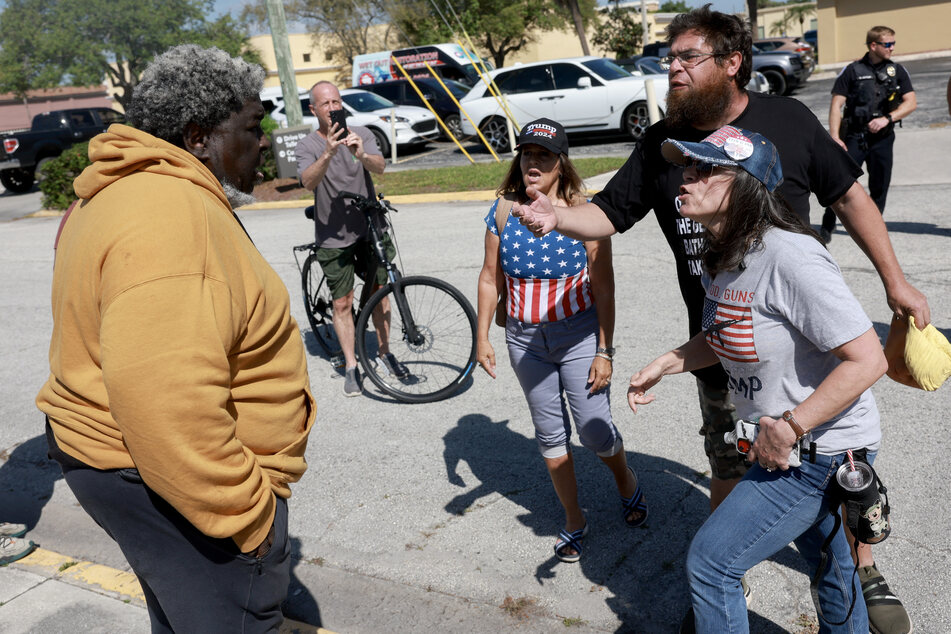 Wayne Ingram (l.), a supporter of President Joe Biden, debates with supporters of former President Donald Trump as they stand outside of the Alto Lee Adams Sr. US Courthouse on Thursday in Fort Pierce, Florida.