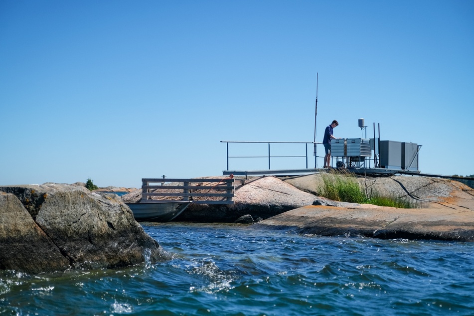 A researcher checks the instruments of an experiment station on a small island that is part of the Tvarminne Zoological Station (TZS), the largest marine research station in the Baltic Sea, in Hanko, Finland on June 26, 2024.