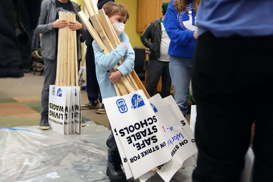 A young student helping out with picket signs during the strike.