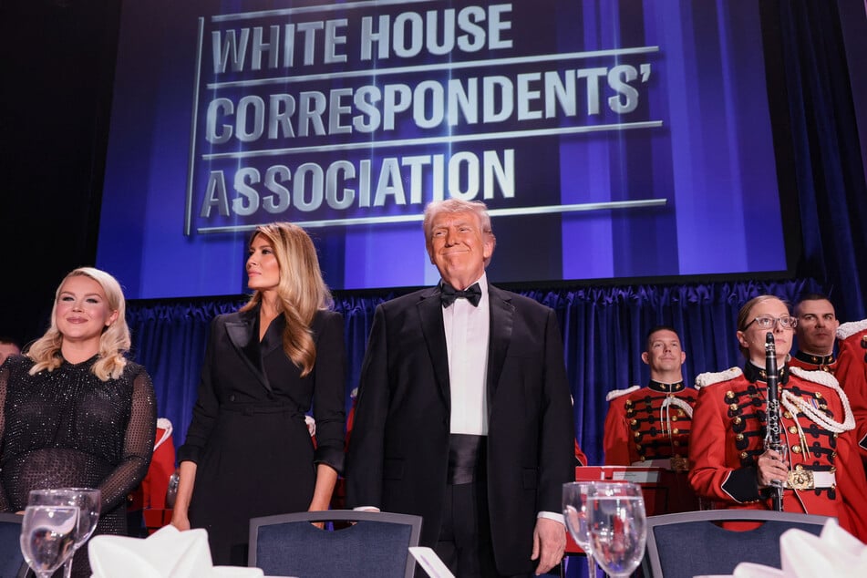 President Donald Trump (c.) on stage at the White House Correspondents' Association Dinner at the Hilton Hotel on Saturday night, moments before he was rushed offstage amid gunshots.
