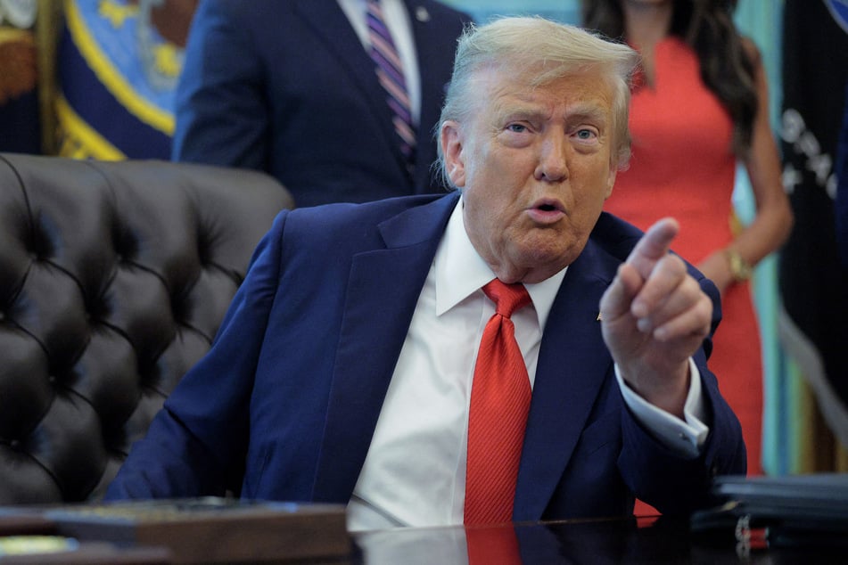President Donald Trump talks to journalists after signing executive orders in the Oval Office at the White House on August 25, 2025.
