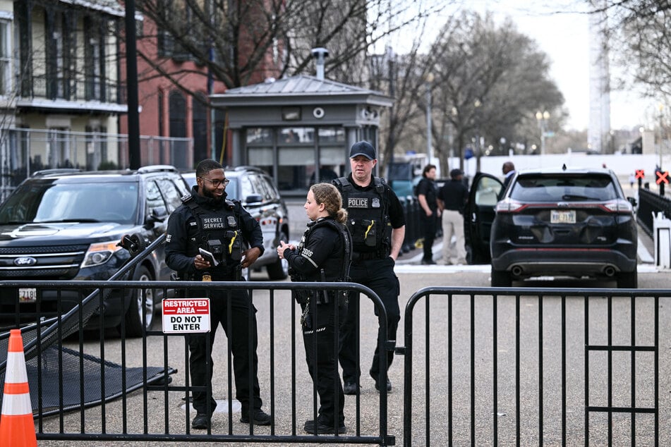 Members of the US Secret Service monitor the scene after a vehicle ran into a security barricade near the White House on March 11, 2026.