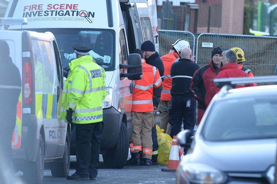 Einsatzkräfte stehen am Ort des Hausbrandes in der Jackson Street in Worsley.