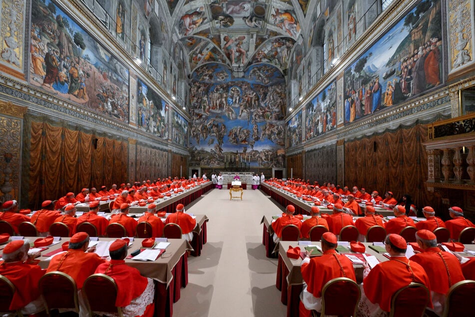 Cardinals pray in the Sistine Chapel, ahead of the conclave to elect the next pope at the Vatican, on May 7, 2025.