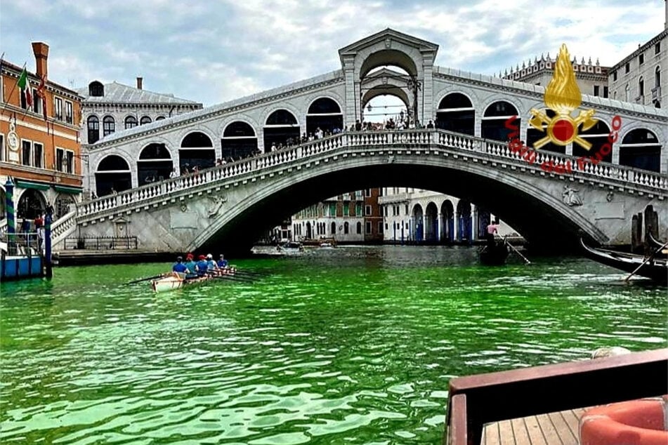 Venice's waters turn green due to an unknown substance near the Rialto Bridge in Venice, Italy.