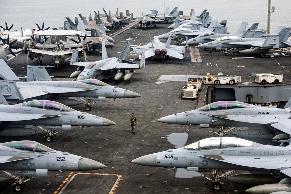 "A big armada" led by the aircraft carrier USS Abraham Lincoln is surrounding Iran, according to President Donald Trump.