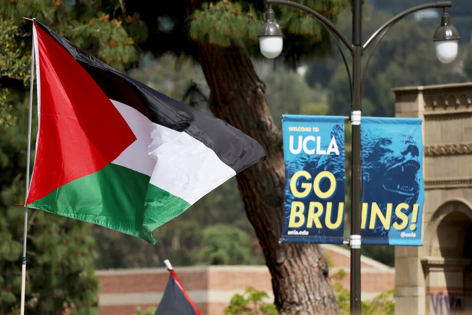 A Palestinian flag flies at an encampment on the UCLA campus on May 1, 2024, the morning after it was attacked by counter-protestors.