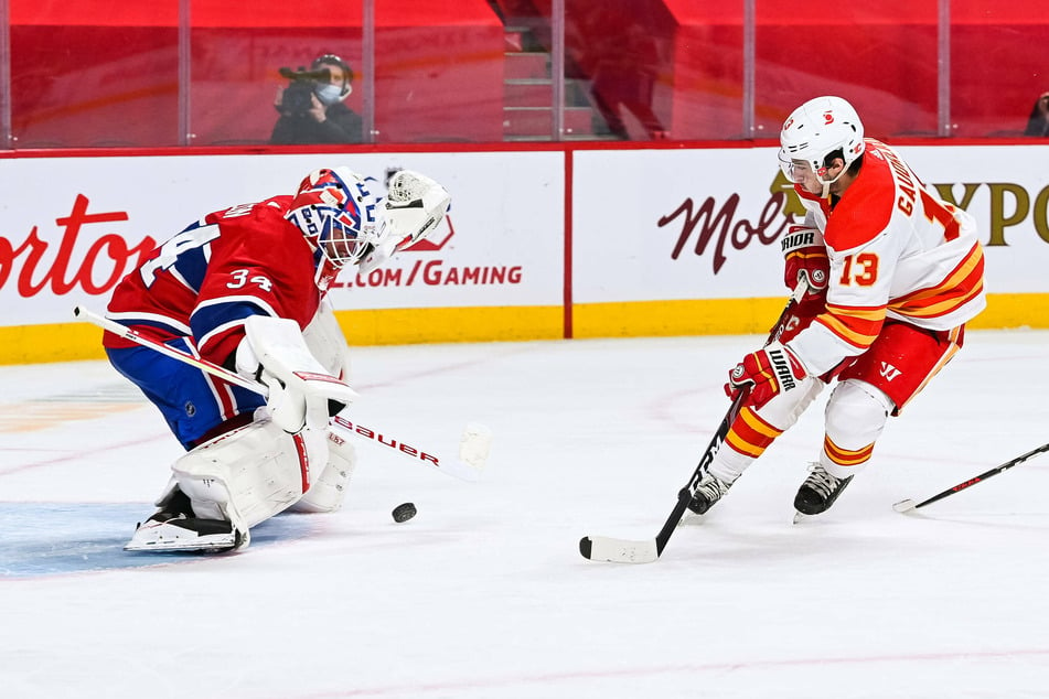 Canadiens goalie Jake Allen makes a save over Calgary Flames left wing Johnny Gaudreau